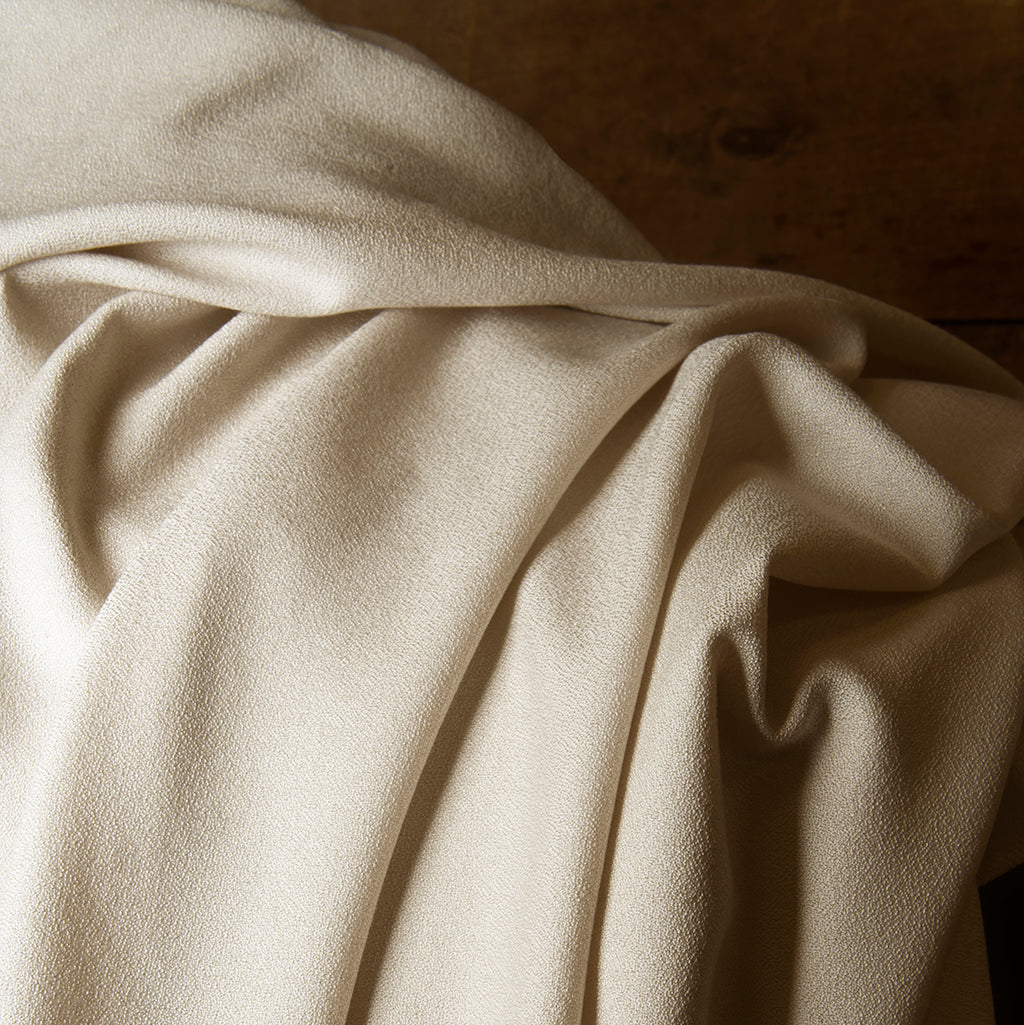 Close-up of beige fabric with folds
