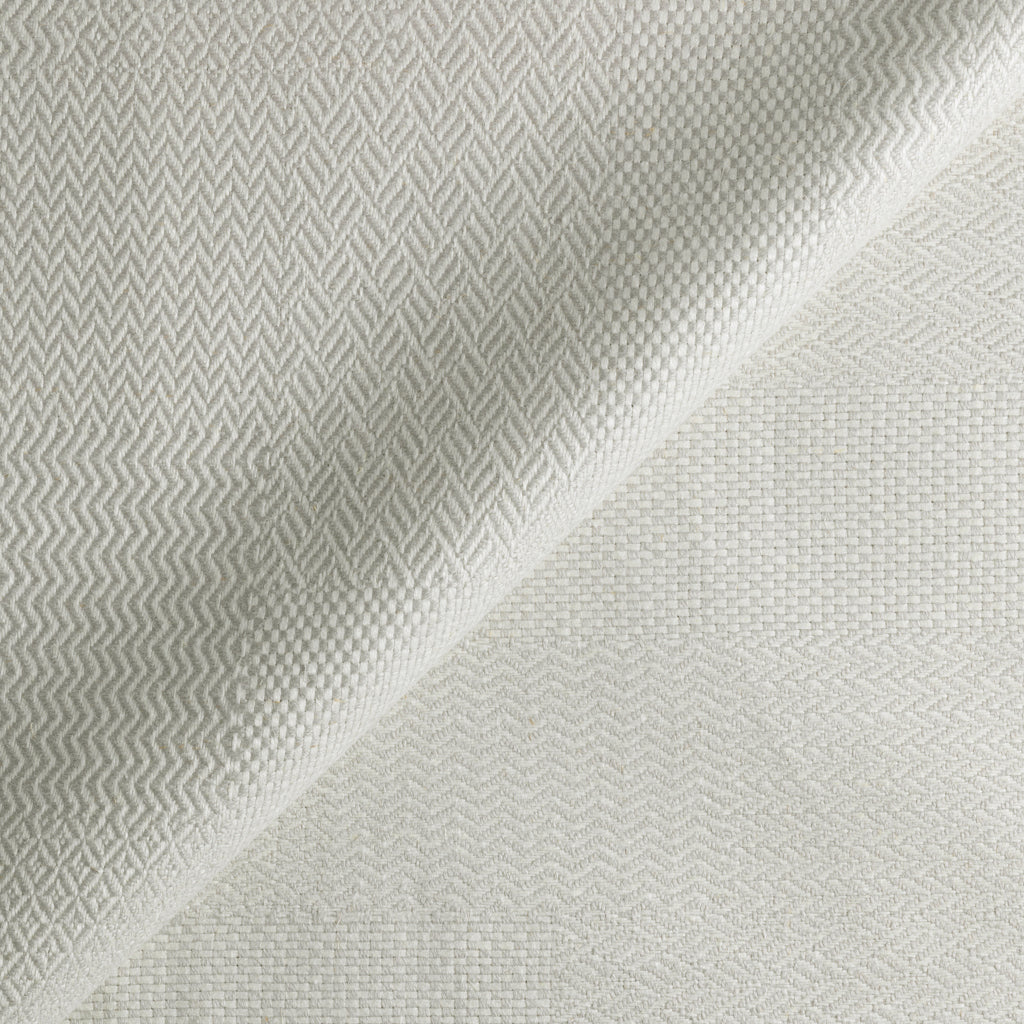 Textured fabric with a subtle pattern on a light gray background