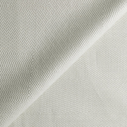 Textured fabric with a subtle pattern on a light gray background