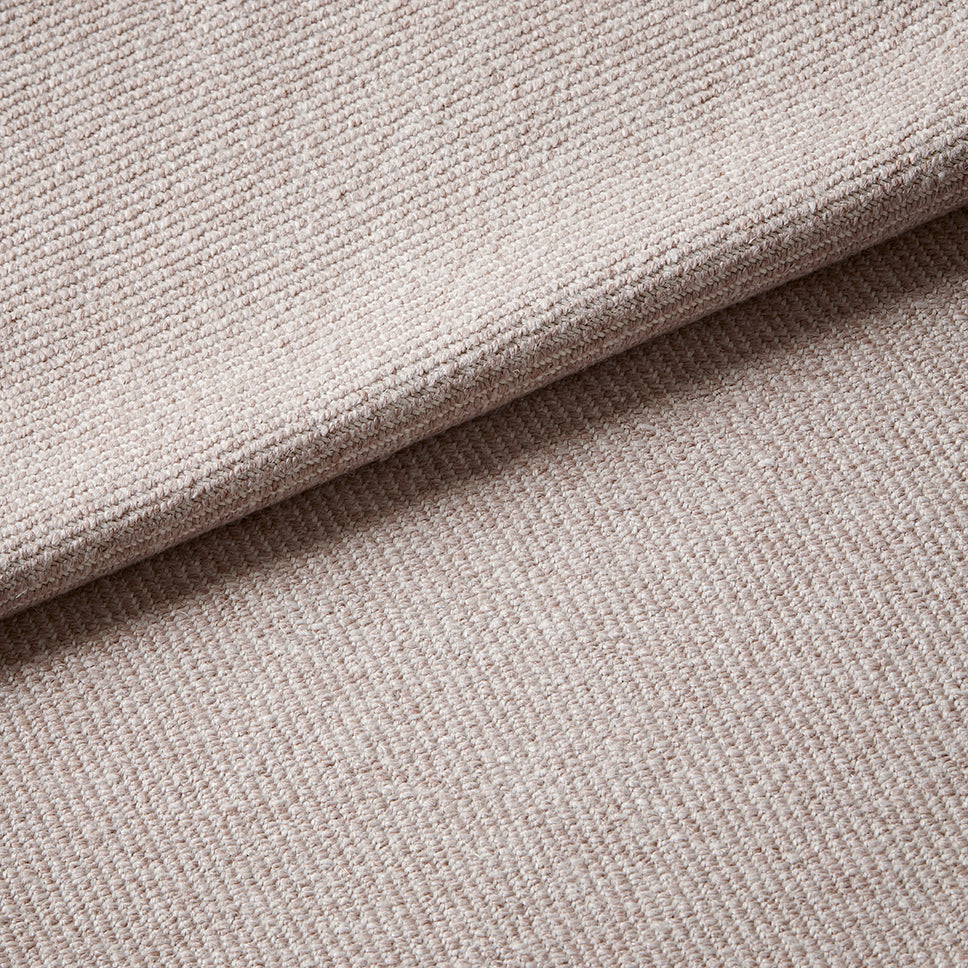 Close-up of textured beige fabric with a slight wave.