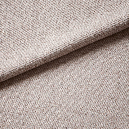 Close-up of textured beige fabric with a slight wave.