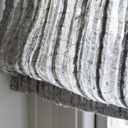 Close-up of textured fabric with horizontal stripes on a neutral background