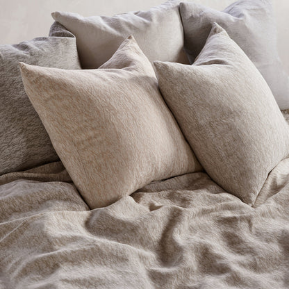 Beige bedding with pillows on a bed